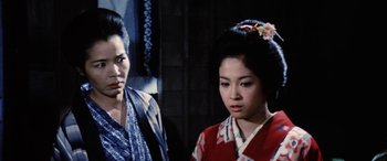 Movie still from “Lady Snowblood” (1973), directed by Toshiya Fujita – Two geishas are standing next to each other; Close Up shot, Low angle