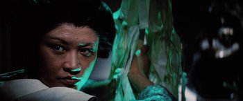 Movie still from “Lady Snowblood” (1973), directed by Toshiya Fujita – A woman's face in a green light; Close Up shot, Low angle
