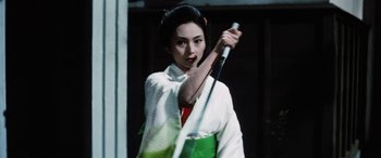 Movie still from “Lady Snowblood” (1973), directed by Toshiya Fujita – A woman in a white kimono holding a white cane; Close Up shot, Low angle
