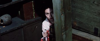 Movie still from “Lady Snowblood” (1973), directed by Toshiya Fujita – A woman holding a knife in a room; Medium shot, High angle