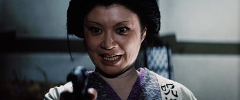 Movie still from “Lady Snowblood” (1973), directed by Toshiya Fujita – A person wearing a costume; Close Up shot, Low angle