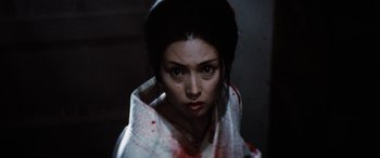 Movie still from “Lady Snowblood” (1973), directed by Toshiya Fujita – A woman with blood all over her face and neck; Close Up shot, High angle