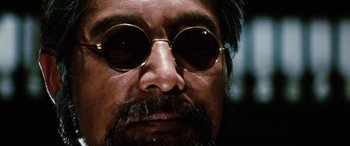 Movie still from “Lady Snowblood” (1973), directed by Toshiya Fujita – A person wearing round sunglasses; Extreme Close Up shot, Low angle