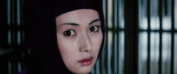 Movie still from “Lady Snowblood” (1973), directed by Toshiya Fujita – A person wearing a headscarf; Close Up shot, Over the shoulder angle