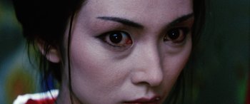 Movie still from “Lady Snowblood” (1973), directed by Toshiya Fujita – A woman's eyes with a red eye; Extreme Close Up shot, High angle