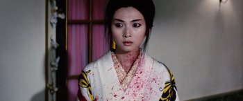 Movie still from “Lady Snowblood” (1973), directed by Toshiya Fujita – A young woman with blood on her face and chest; Close Up shot, High angle