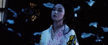 Movie still from “Lady Snowblood” (1973), directed by Toshiya Fujita – A woman with blood all over her face and neck; Close Up shot, Low angle