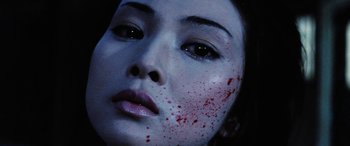 Movie still from “Lady Snowblood” (1973), directed by Toshiya Fujita – A person with blood on their face; Extreme Close Up shot, Overhead angle