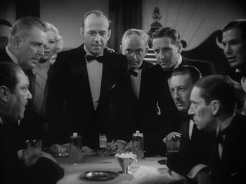 Movie still from “Lady for a Day” (1933), directed by Frank Capra – A black and white photo of a group of men at a dinner table; Medium shot, Over the shoulder angle