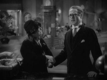 Movie still from “Lady for a Day” (1933), directed by Frank Capra – A man and a woman shaking hands in a room; Medium shot, Over the shoulder angle