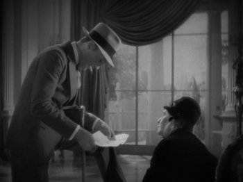 Movie still from “Lady for a Day” (1933), directed by Frank Capra – An old photo of a man and a woman; Medium shot, High angle