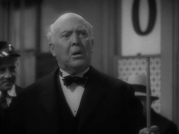Movie still from “Lady for a Day” (1933), directed by Frank Capra – An older man in a suit and bow tie; Close Up shot, Low angle