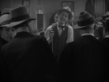 Movie still from “Lady for a Day” (1933), directed by Frank Capra – A group of men standing next to each other in front of a mirror; Medium shot, High angle