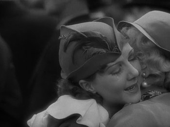 Movie still from “Lady for a Day” (1933), directed by Frank Capra – A woman in a hat hugging another woman in a hat; Close Up shot, Low angle