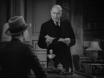 Movie still from “Lady for a Day” (1933), directed by Frank Capra – An old photo of a man in a suit and hat reading a paper; Medium shot, Low angle