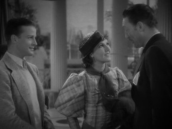 Movie still from “Lady for a Day” (1933), directed by Frank Capra – A black and white photo of a man and two women; Medium shot, Over the shoulder angle