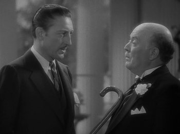 Movie still from “Lady for a Day” (1933), directed by Frank Capra – A man and a man holding a cane in a black and white photo; Close Up shot, Low angle