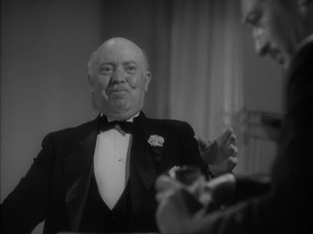 Movie still from “Lady for a Day” (1933), directed by Frank Capra – An older man wearing a tuxedo in front of a mirror; Close Up shot, Low angle