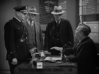 Movie still from “Lady for a Day” (1933), directed by Frank Capra – A group of men standing next to each other in a room; Medium shot, Low angle