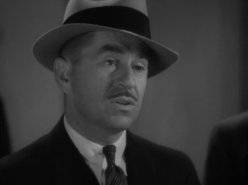 Movie still from “Lady for a Day” (1933), directed by Frank Capra – An older man wearing a suit and a hat; Close Up shot, High angle