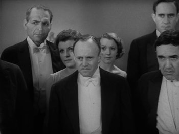 Movie still from “Lady for a Day” (1933), directed by Frank Capra – A black and white photo of a group of people; Medium shot, Low angle