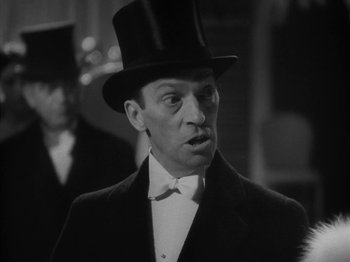 Movie still from “Lady for a Day” (1933), directed by Frank Capra – A man wearing a top hat and a bow tie; Close Up shot, Low angle