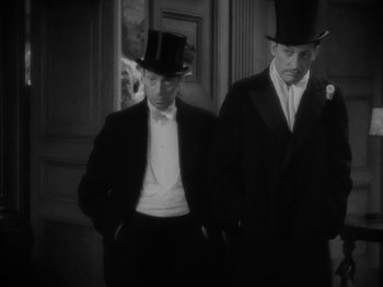Movie still from “Lady for a Day” (1933), directed by Frank Capra – Two men in top hats and suits standing next to each other; Medium shot, High angle