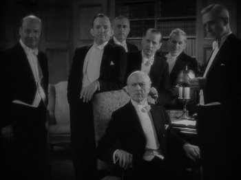 Movie still from “Lady for a Day” (1933), directed by Frank Capra – A black and white photo of a group of men in tuxedos; Medium shot, High angle