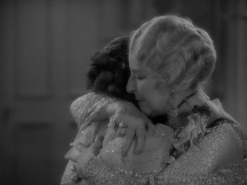 Movie still from “Lady for a Day” (1933), directed by Frank Capra – An older woman hugging a younger woman in a black and white photo; Medium shot, Over the shoulder angle