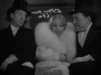 Movie still from “Lady for a Day” (1933), directed by Frank Capra – A black - and - white photo of a man and two women; Medium shot, High angle