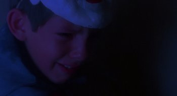 Movie still from “Lady in White” (1988), directed by Frank LaLoggia – A young boy wearing a paper hat in the dark; Close Up shot, Low angle