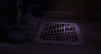 Movie still from “Lady in White” (1988), directed by Frank LaLoggia – A floor grate sitting on top of a wooden floor; Extreme Close Up shot, High angle