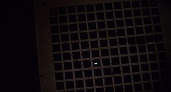 Movie still from “Lady in White” (1988), directed by Frank LaLoggia – A light in the middle of a dark room; Extreme Wide shot, Overhead angle