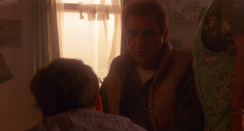 Movie still from “Lady in White” (1988), directed by Frank LaLoggia – A man in a brown jacket talking to another man in a brown jacket; Medium shot, Over the shoulder angle