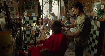 Movie still from “Everybody Knows” (2018), directed by Asghar Farhadi – A group of people sitting around a barber shop; Medium shot, Over the shoulder angle