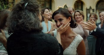 Movie still from “Everybody Knows” (2018), directed by Asghar Farhadi – A woman in a white dress holding her mouth open; Close Up shot, Over the shoulder angle