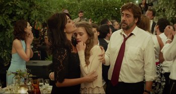 Movie still from “Everybody Knows” (2018), directed by Asghar Farhadi – Two women and a man in a crowd of people; Medium shot, Over the shoulder angle