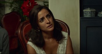 Movie still from “Everybody Knows” (2018), directed by Asghar Farhadi – A woman sitting in a chair looking at the camera; Close Up shot, Over the shoulder angle