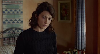 Movie still from “Everybody Knows” (2018), directed by Asghar Farhadi – A woman in a black sweater is looking at the camera; Close Up shot, Over the shoulder angle