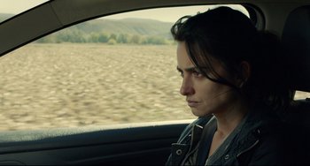 Movie still from “Everybody Knows” (2018), directed by Asghar Farhadi – A woman sitting in the back seat of a car looking out the window; Close Up shot, Over the shoulder angle