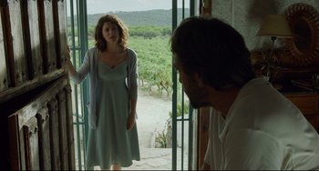 Movie still from “Everybody Knows” (2018), directed by Asghar Farhadi – A man and a woman standing in front of an open door; Medium shot, Over the shoulder angle