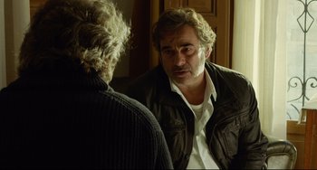 Movie still from “Everybody Knows” (2018), directed by Asghar Farhadi – A man looking at himself in the mirror; Close Up shot, Over the shoulder angle