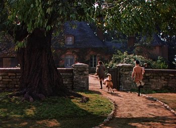 Movie still from “Lassie Come Home” (1943), directed by Fred M. Wilcox – A couple of people and a dog walking down a path; Extreme Wide shot, High angle