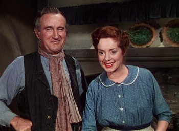 Movie still from “Lassie Come Home” (1943), directed by Fred M. Wilcox – An older man standing next to an older woman; Medium shot, Low angle