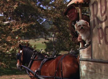 Movie still from “Lassie Come Home” (1943), directed by Fred M. Wilcox – A man and a dog in a carriage pulled by a horse; Wide shot, Over the shoulder angle
