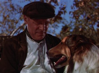 Movie still from “Lassie Come Home” (1943), directed by Fred M. Wilcox – An older man wearing a hat with a dog in front of him; Close Up shot, Low angle