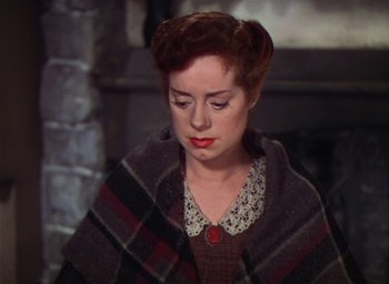 Movie still from “Lassie Come Home” (1943), directed by Fred M. Wilcox – A woman with a blanket wrapped around her shoulders; Close Up shot, High angle