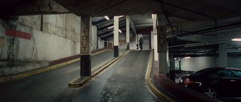 Movie still from “Last Chance Harvey” (2008), directed by Joel Hopkins – A man walking down a ramp in an empty parking garage; Extreme Wide shot, High angle
