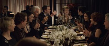 Movie still from “Last Chance Harvey” (2008), directed by Joel Hopkins – A group of people sitting at a dinner table drinking wine; Medium shot, Over the shoulder angle