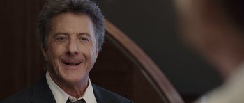 Movie still from “Last Chance Harvey” (2008), directed by Joel Hopkins – An older man in a suit and tie smiling for the camera; Close Up shot, Over the shoulder angle